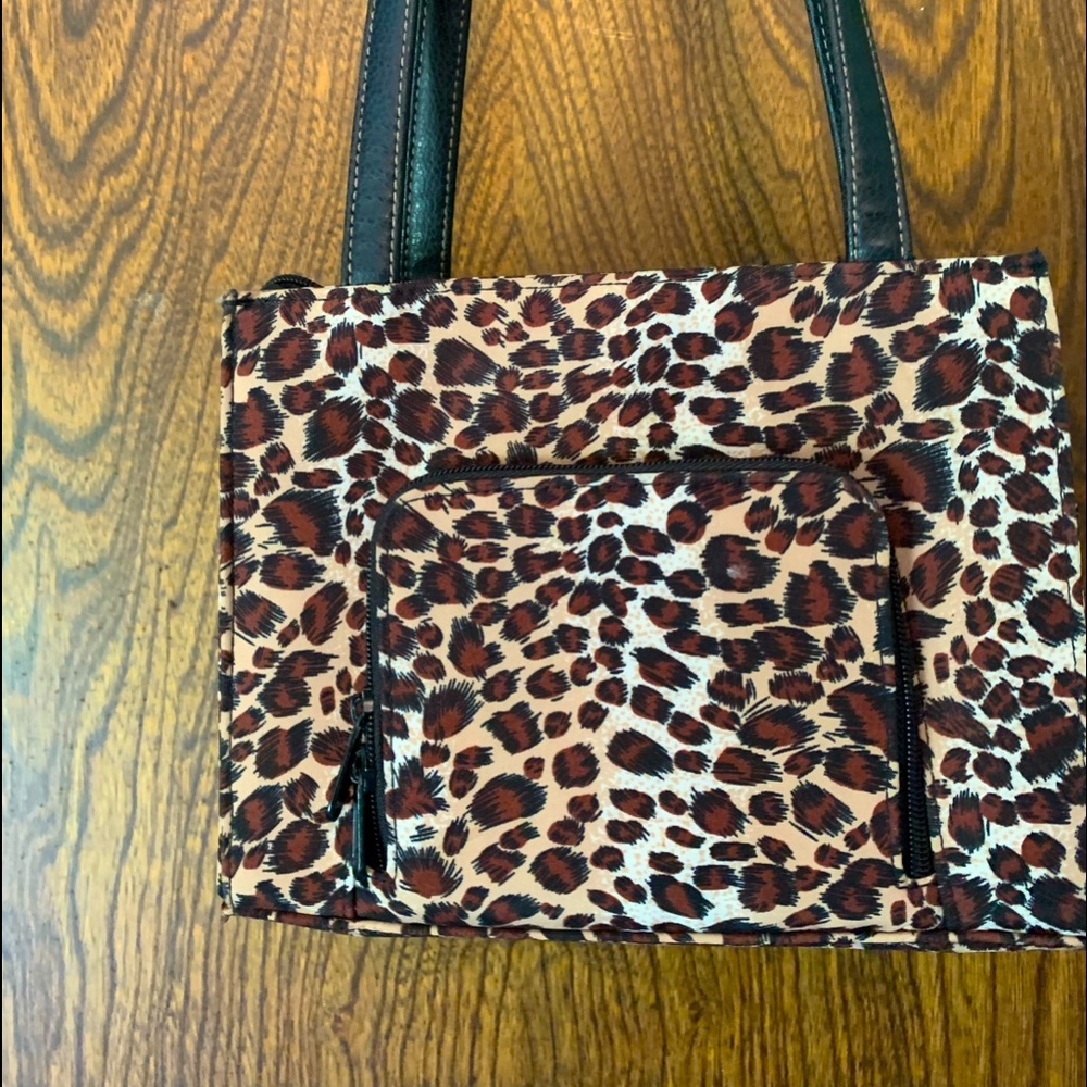 Small purse leopard print zipper pocket on the front wallet pocket on the back.
